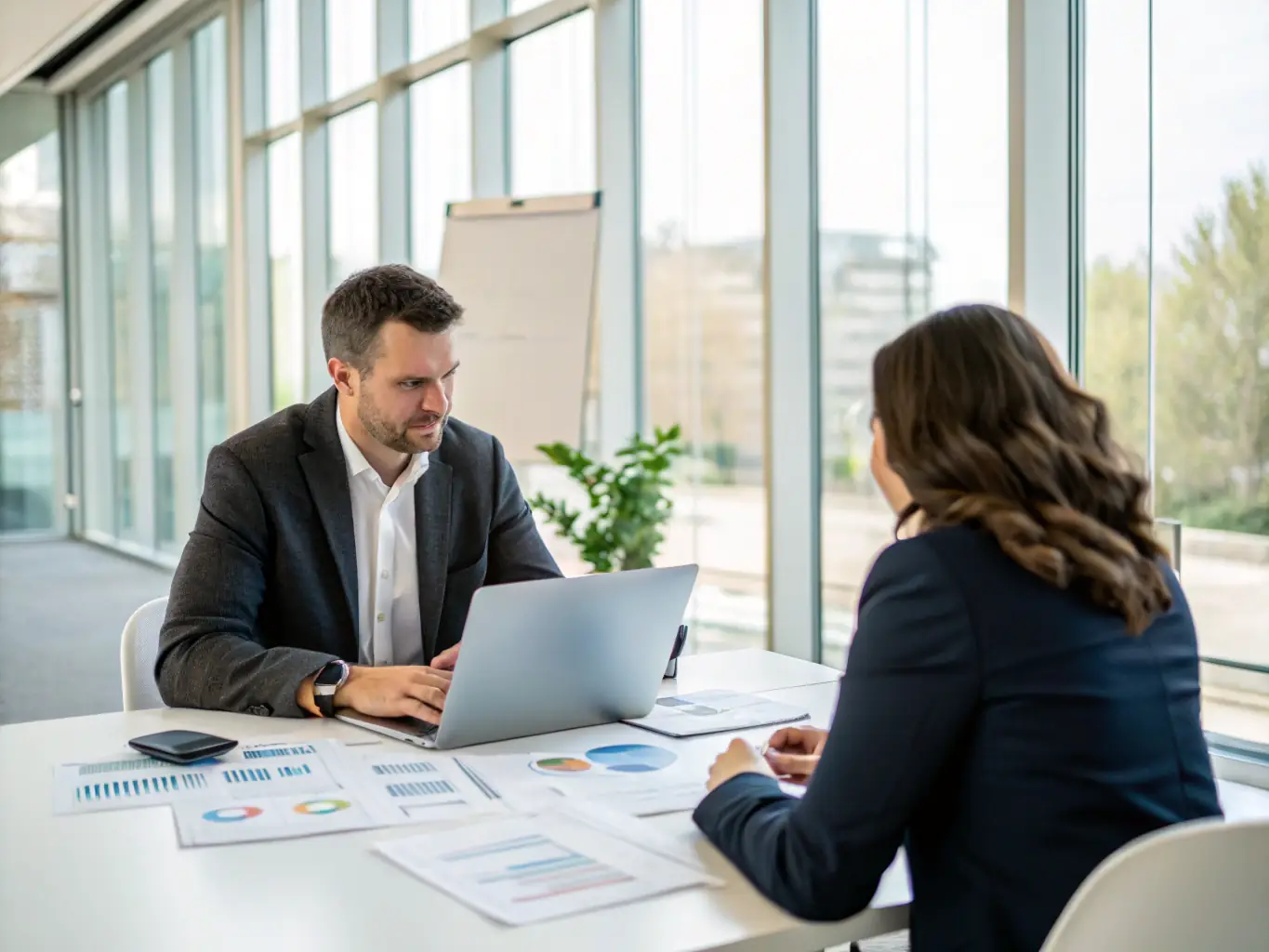 A consultant working with a client on a market entry strategy, reviewing documents and discussing plans in a modern office environment.
